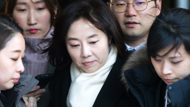 South Korean Culture Minister Cho Yoon-sun, center, leaves the Seoul Central District Court in Seoul after attending a hearing on Friday.