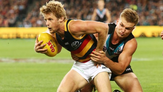 Full pressure: Power's Ollie Wines tackles Rory Sloane.