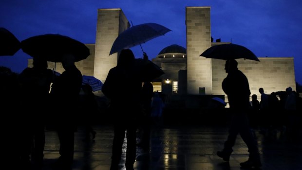 Canberrans braved the rain to attend the dawn service.