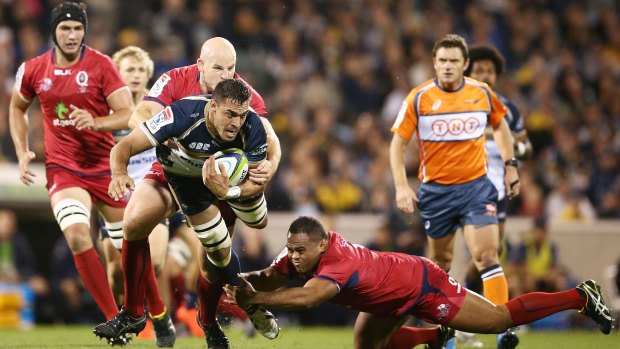 Rory Arnold of the Brumbies is tackled.