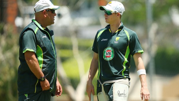 Captain sensible: Steve Smith talks with coach Darren Lehmann at training in Brisbane.