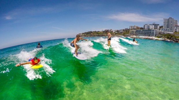 Surfers swarm on Bondi Beach for the first day of summer, as temperatures hit 38 degrees.