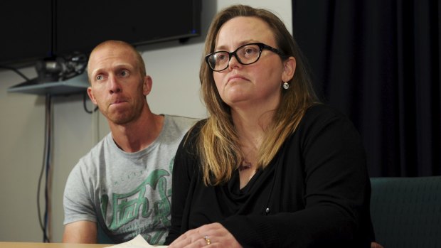 Jenny Heddle, the wife of missing Chisholm man Stuart Heddle,
makes a public plea at the Woden Police Station. At left is Mr Heddle's brother Ian.