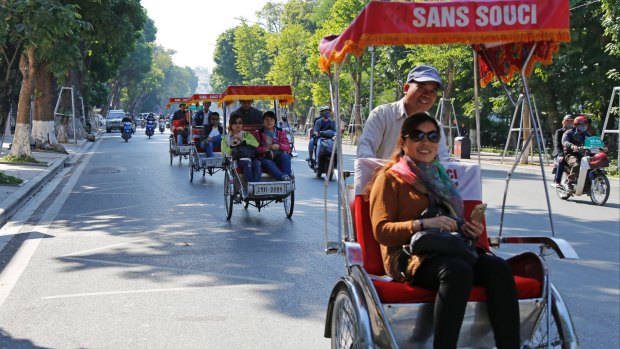 Chinese tourists ride rickshaws for sightseeing in Hanoi, Vietnam.