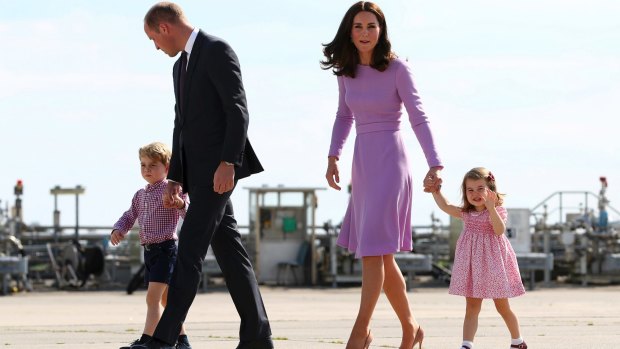 Prince William and his wife Kate, the Duchess of Cambridge, with their children Prince George and Princess Charlotte, on their way to board a plane in Hamburg, Germany. 