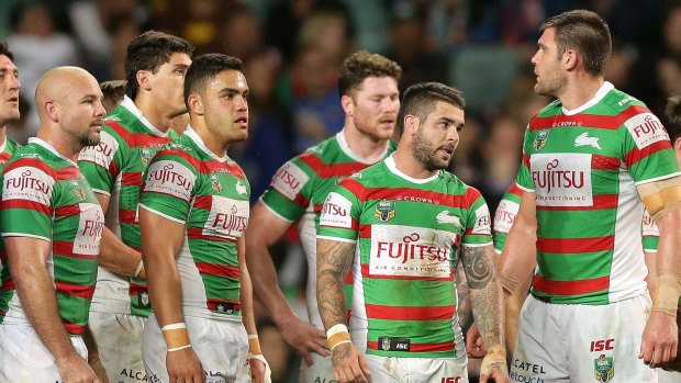 Down and rout: Rabbitohs players look dejected after conceding another try on Friday night.