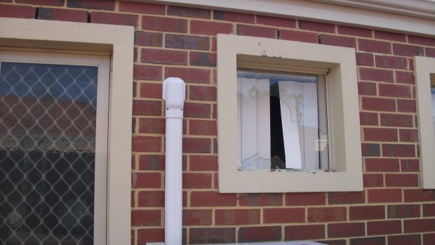 The smashed window - which Betty Foo says a tile went through.