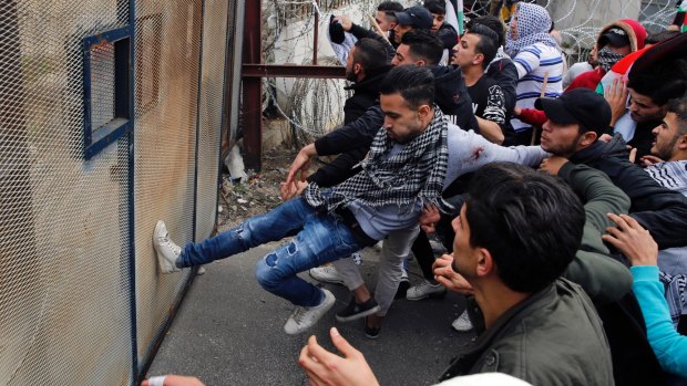 Protesters try to enter the US embassy during a demonstration in Aukar, east of Beirut, Lebanon.