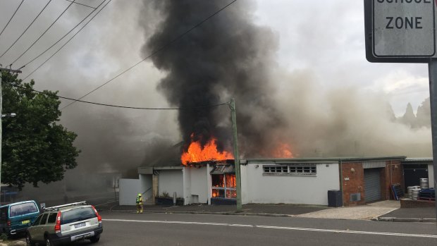 A firefighter prepares to battle the blaze consuming Katoomba RSL.