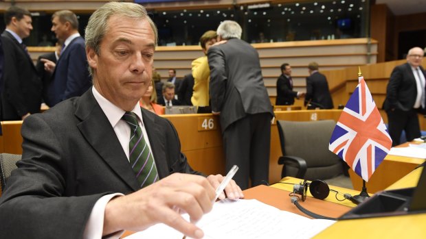 UKIP leader Nigel Farage sits next to a British flag during a special session of European Parliament.