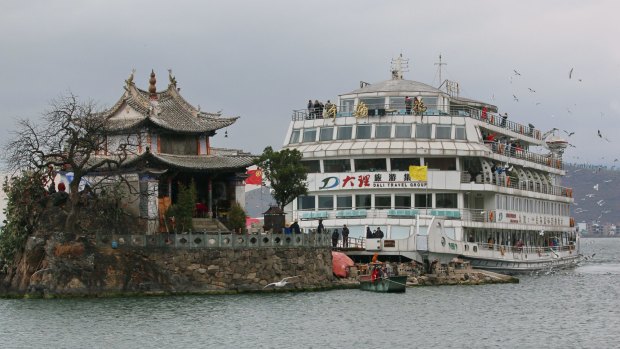 A tourist cruise boat berths at Little Putuo Temple on Erhai Lake in Dali.