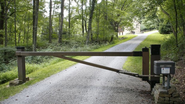 A gate blocks the driveway where an outbuilding is visible on the property of Dr Jan Seski in Pennsylvania.