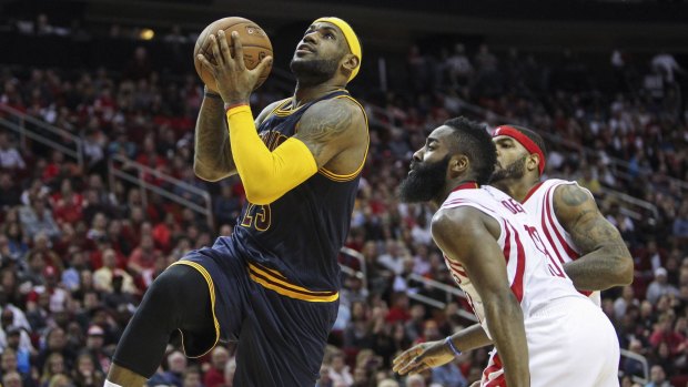 Too hard to guard: Cleveland Cavaliers forward LeBron James drives the ball to the basket past Houston opponent James Harden.