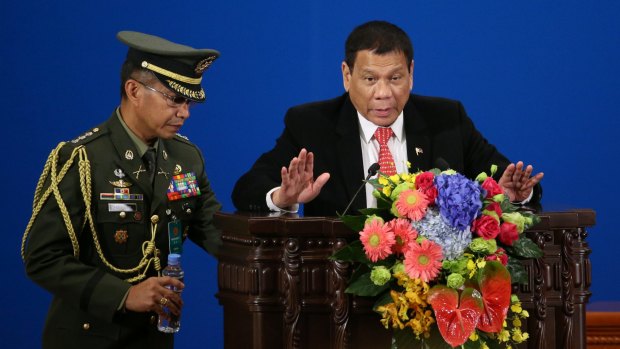 Philippines President Rodrigo Duterte, right, makes a speech during the Philippines-China Trade and Investment Fourm at the Great Hall of the People in Beijing on Thursday.