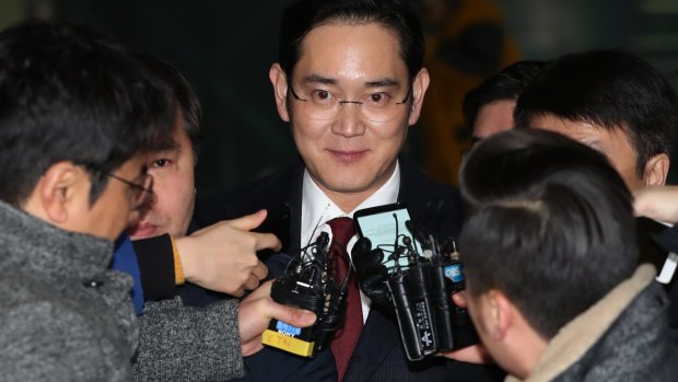 Jay Y. Lee, co-vice chairman of Samsung Electronics, surrounded by members of the media as he leaves the special prosecutors' office in Seoul on January 13.