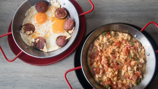 Sunny-side-up eggs with spicy sucuk and menemen, a just-set scramble of  capsicums, tomato and parsley.