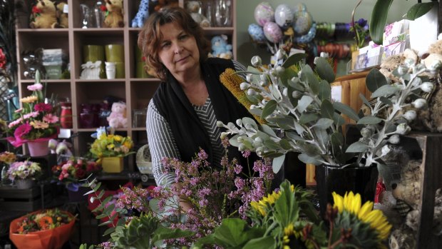Owner of the florist shop Florever, Valerie Kivshar, is concerned about loss of business when supermarket giants Aldi and Coles are built at the Dickson shops.