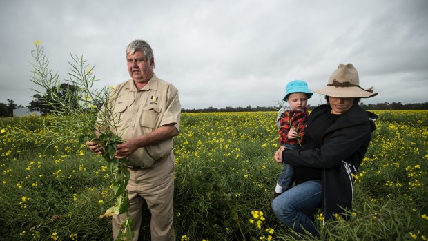 Neil Mattiske with his daughter Joanne and grandson Riley on their flood affected farm near Forbes 