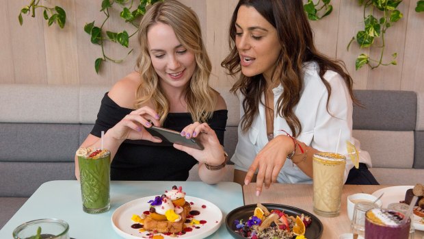 Jackie Doran, left, from Yelp, and Josephine Pulitano, manager at Kitty Burns eatery in Abbotsford, compare food photography notes.