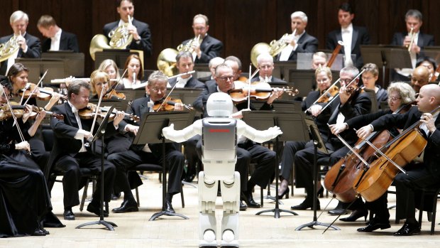 Honda's ASIMO robot conducts the Detroit Symphony Orchestra in May 2008.