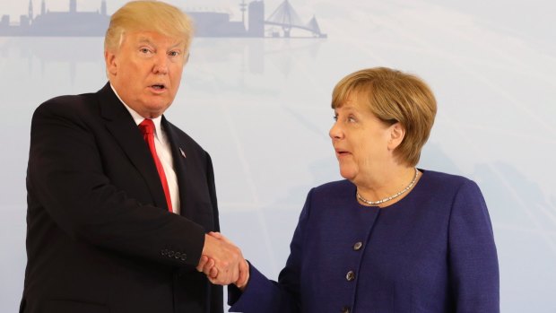 Better luck this time: US President Donald Trump and German Chancellor Angela Merkel successfully shake hands on the eve of the G20 summit in Hamburg.