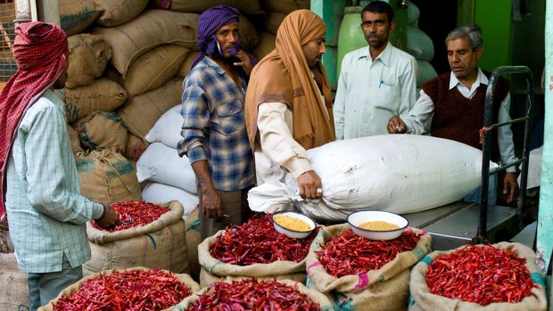 Businessmen and porters at a stall selling red chillies at the Old Delhi Spice Market in Khari Baoli Road. 