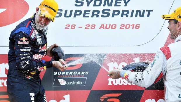 Jamie Whincup, winner of the Sydney SuperSprint, is sprayed by vanquished teammate Craig Lowndes.