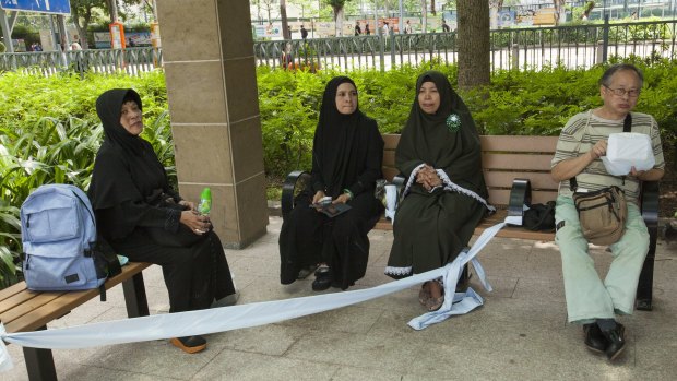 Religious Indonesian domestic helpers improvise a women-only seating area in Hong Kong's Victoria Park on their day off.