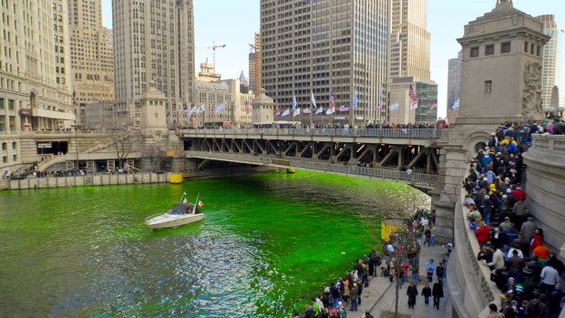 Spectators gather for the greening of the river in downtown Chicago.