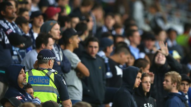 Police keep an eye on the crowd during the match between Melbourne Victory and Adelaide United.