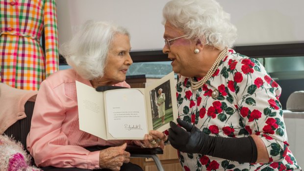 'The Queen', aka comedian Gerry Connolly, right, delivered the real Queen Elizabeth's certificate to fashion designer  Elvie Hill, left, at Elvie's 100th birthday in Brighton.