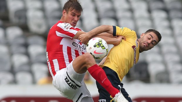 City slackers: Melbourne City's Erik Paartalu tussles with Anthony Caceres of the Mariners.