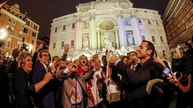 Gay rights activists celebrate in front of Rome's historical Trevi fountain after a law was passed recognising the civil unions of same-sex couples. 