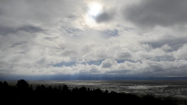 The sun creeps through the clouds on Monday morning after a weekend of rain at Lake George.