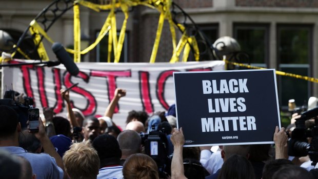 Protesters gather outside the governor's residence in Minnesota on Thursday.