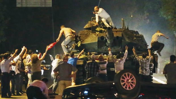 Civilians attempt to stop a tank in the Turkish capital Ankara during the coup attempt on July 16, 2016. 