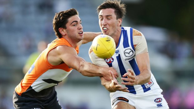 Young Giant Tim Taranto challenges North Melbourne's Sam Wright.