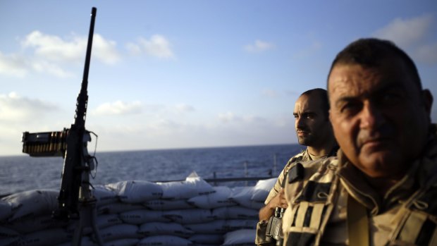 Sailor First Class Jonathan Willems, left, and Master Chief ScubaDiver Ervin Durlinger patrol for migrants aboard of the Belgian Navy Vessel Godetia in the Mediterranean Sea off the Libyan coast.