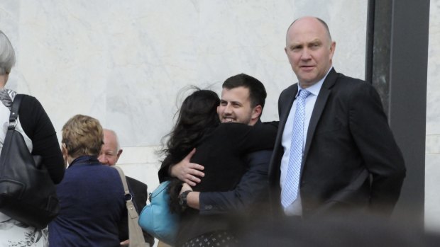Harlan Agresti hugs members of his family outside court.