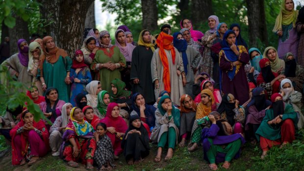 Kashmiri women watch the body of Sabzar Ahmed Bhat being displayed in Tral.