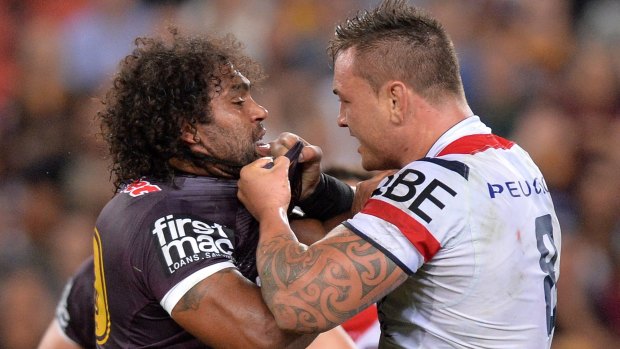 Push and shove: Broncos forward Sam Thaiday and Roosters prop Jared Waerea-Hargreaves face off at Suncorp Stadium last Friday.