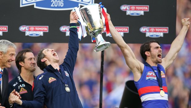 Easton Wood, Robert Murphy of the Bulldogs and Luke Beveridge, coach of the Bulldogs celebrate with the 2016 AFL Premiership Cup during the 2016 Toyota AFL Grand Final match between the Sydney Swans and the Western Bulldogs at the Melbourne Cricket Ground on October 1, 2016 in Melbourne, Australia.