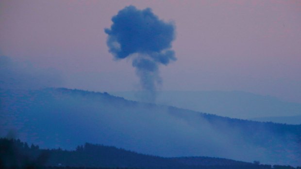 Plumes of smoke rise from inside Syria, as seen from the outskirts of the border town of Kilis, Turkey.
