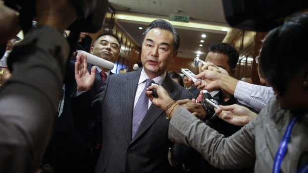 Chinese Foreign Minister Wang Yi is surrounded by journalists at the Association of Southeast Asian Nations (ASEAN) Foreign Ministers Meeting in Kuala Lumpur on Tuesday. 