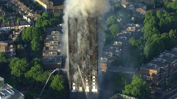 In this photo taken from aerial video, smoke rises from a high-rise apartment building on fire in London, Wednesday, June 14, 2017.