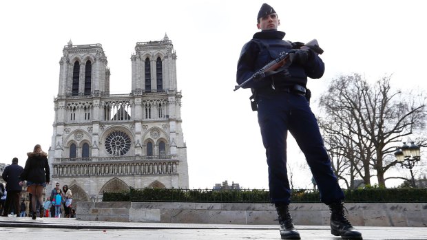 A French police officer stands guard outside Notre Dame cathedral in Paris earlier this year.