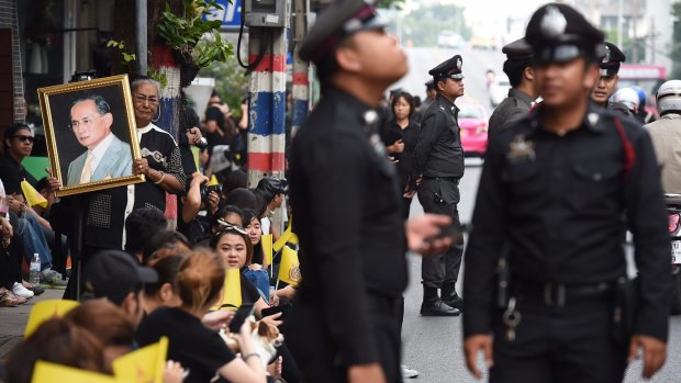 Police officers on duty dressed in black for King Bhumibol Adulyadej's death at the age of 88.