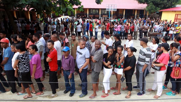 People queue up to give their vote during the presidential election at a polling station in Dili, East Timor,.
