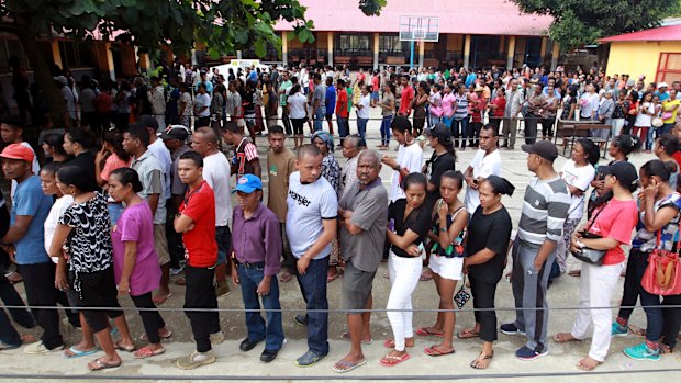 People queue up to give their vote during the presidential election at a polling station in Dili, East Timor,.