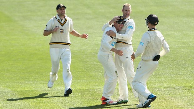Adam Voges embraces teammate Marcus Harris after he dismissed Peter Siddle of Victoria.